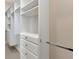 Custom walk-in closet with white cabinets, drawers, and shelving at 5451 Prime Ter, North Port, FL 34286