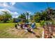 Expansive backyard offers a delightful outdoor seating area surrounded by lush greenery and a charming shed at 611 Bonita Ct, Punta Gorda, FL 33950