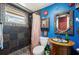 Stylized bathroom features colorful walls, a decorative mirror, and unique sink at 611 Bonita Ct, Punta Gorda, FL 33950