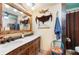 Bathroom with double vanity, decorative accents, and unique design details at 611 Bonita Ct, Punta Gorda, FL 33950