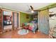 This stylish bedroom boasts colorful decor, a ceiling fan, and an ensuite bathroom at 611 Bonita Ct, Punta Gorda, FL 33950
