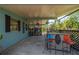 Outdoor covered patio features a bar and seating area, perfect for entertaining or relaxing with a view of the lush backyard at 611 Bonita Ct, Punta Gorda, FL 33950