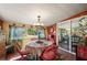 Bright dining area features a round table, garden views and charming decor at 611 Bonita Ct, Punta Gorda, FL 33950