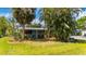 Charming home with a metal roof, tidy landscaping, and mature palm trees offers great curb appeal at 611 Bonita Ct, Punta Gorda, FL 33950