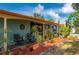 Charming covered patio with seating and lush landscaping at 611 Bonita Ct, Punta Gorda, FL 33950