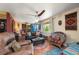Comfortable living room with a ceiling fan, plush seating, and rustic accents at 611 Bonita Ct, Punta Gorda, FL 33950