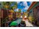 Cozy patio area featuring comfortable seating, decorative plants, and a unique frog-themed water feature, perfect for relaxation at 611 Bonita Ct, Punta Gorda, FL 33950