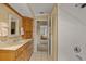 Bright bathroom with natural wood cabinets, granite countertops, and walk-in shower at 632 Brindisi Ct, Punta Gorda, FL 33950