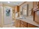 Bathroom featuring wood cabinets, a decorative mirror, and white tiled floors at 632 Brindisi Ct, Punta Gorda, FL 33950