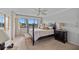 Bedroom with four-poster bed and a large window providing beautiful water views at 632 Brindisi Ct, Punta Gorda, FL 33950