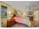 Cozy bedroom with colorful rug, wood furniture, and doorway to ensuite bathroom at 632 Brindisi Ct, Punta Gorda, FL 33950