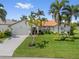 Charming single-story home with well-manicured lawn and mature palm trees at 632 Brindisi Ct, Punta Gorda, FL 33950