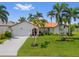 Charming single-story home with a well-manicured lawn, mature palm trees, and a welcoming front entrance at 632 Brindisi Ct, Punta Gorda, FL 33950