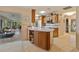 Kitchen view featuring an island, white countertops, wooden cabinetry, and open view to living room at 632 Brindisi Ct, Punta Gorda, FL 33950