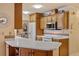 Kitchen view featuring white countertops, wooden cabinetry, and open view to dining area at 632 Brindisi Ct, Punta Gorda, FL 33950