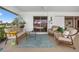 Enclosed lanai with comfortable seating and views of the lush landscaping and blue sky at 632 Brindisi Ct, Punta Gorda, FL 33950