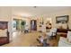 Bright living room featuring light wood flooring, elegant furnishings, and view of the pool area at 632 Brindisi Ct, Punta Gorda, FL 33950