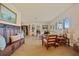 Spacious living room featuring hardwood floors, plantation shutters, and classic furnishings at 632 Brindisi Ct, Punta Gorda, FL 33950