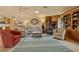 Bright living room features custom built-in shelving, comfortable seating, and tile flooring at 632 Brindisi Ct, Punta Gorda, FL 33950