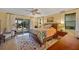 Main bedroom features light wood flooring and a view of the pool area through sliding glass doors at 632 Brindisi Ct, Punta Gorda, FL 33950