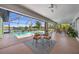 Enclosed pool with seating area and clear view of the waterfront at 632 Brindisi Ct, Punta Gorda, FL 33950