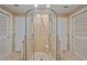 Tiled shower with glass enclosure, built-in bench, and adjacent closet doors at 632 Brindisi Ct, Punta Gorda, FL 33950