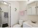Well lit bathroom features a shower with glass doors, neutral paint, and tiled walls at 6764 Stardust Ave, North Port, FL 34287