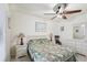 Bedroom features bright walls, tile flooring, a ceiling fan, and neutral paint at 6764 Stardust Ave, North Port, FL 34287