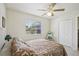 Bedroom with tiled floors, ceiling fan, and a window with blinds at 6764 Stardust Ave, North Port, FL 34287