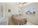 Bright bedroom featuring a ceiling fan, tiled floors, and a window for natural light at 6764 Stardust Ave, North Port, FL 34287
