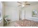 Bedroom with white woven furniture, ceiling fan, and tile floors at 6764 Stardust Ave, North Port, FL 34287