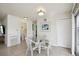 Cozy dining area with a glass table and views into the hall bathroom at 6764 Stardust Ave, North Port, FL 34287