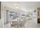 Bright dining area featuring tile flooring, a glass top table and access to an outdoor patio at 6764 Stardust Ave, North Port, FL 34287