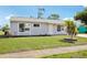Well-maintained single-Gathering home with a beautiful lawn and mature landscaping at 6764 Stardust Ave, North Port, FL 34287