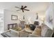 Cozy living room with neutral colors, ceiling fan, comfortable seating, and natural light at 6764 Stardust Ave, North Port, FL 34287