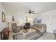 Inviting living room with ceiling fan, neutral decor, comfortable seating, and ample natural light at 6764 Stardust Ave, North Port, FL 34287