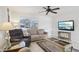 Comfortable living room with a ceiling fan, plush seating, and a view of the outdoors at 6764 Stardust Ave, North Port, FL 34287