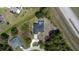 Ariel view of a single Gathering home with a screened in pool, driveway and lush backyard at 6794 Loffreda Ave, North Port, FL 34291