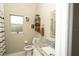 Bright bathroom featuring a granite countertop vanity, wall art, and decorative towel storage at 6794 Loffreda Ave, North Port, FL 34291