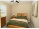 Well-lit bedroom featuring a ceiling fan, neutral walls, and a wooden bed frame with a green comforter at 6794 Loffreda Ave, North Port, FL 34291