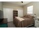 Cozy bedroom with a ceiling fan, a large window, and built-in shelving at 6794 Loffreda Ave, North Port, FL 34291