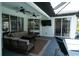 Outdoor patio featuring comfortable seating, ceiling fans, and a view of the pool area at 6794 Loffreda Ave, North Port, FL 34291