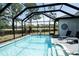 Inviting screened-in pool area featuring a shimmering pool and ample space for outdoor enjoyment at 6794 Loffreda Ave, North Port, FL 34291