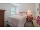 Cozy bedroom with a comfortable bed, window for natural light, and side tables with lamps at 7292 Mikasa Dr, Punta Gorda, FL 33950