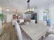 Open-concept dining area with a view of the kitchen, living room, and patio through sliding glass doors at 7292 Mikasa Dr, Punta Gorda, FL 33950