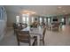 Bright community dining room featuring multiple tables, comfortable seating, and ample natural light from large windows at 7292 Mikasa Dr, Punta Gorda, FL 33950
