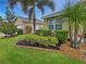 Professionally landscaped front yard featuring vibrant plants, mulch beds, and healthy green lawn enhancing curb appeal at 7292 Mikasa Dr, Punta Gorda, FL 33950