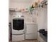Practical laundry area with modern washer and dryer, plus ample shelving for storage solutions at 7292 Mikasa Dr, Punta Gorda, FL 33950