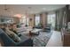 Open-concept community living room showcasing stylish furniture, a chic rug, and bright windows with views at 7292 Mikasa Dr, Punta Gorda, FL 33950