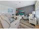 Inviting living room features a neutral palette, a large screen television and comfortable seating at 7292 Mikasa Dr, Punta Gorda, FL 33950